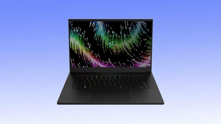 A laptop with a black keyboard and a colorful digital art screen on a gradient blue background.