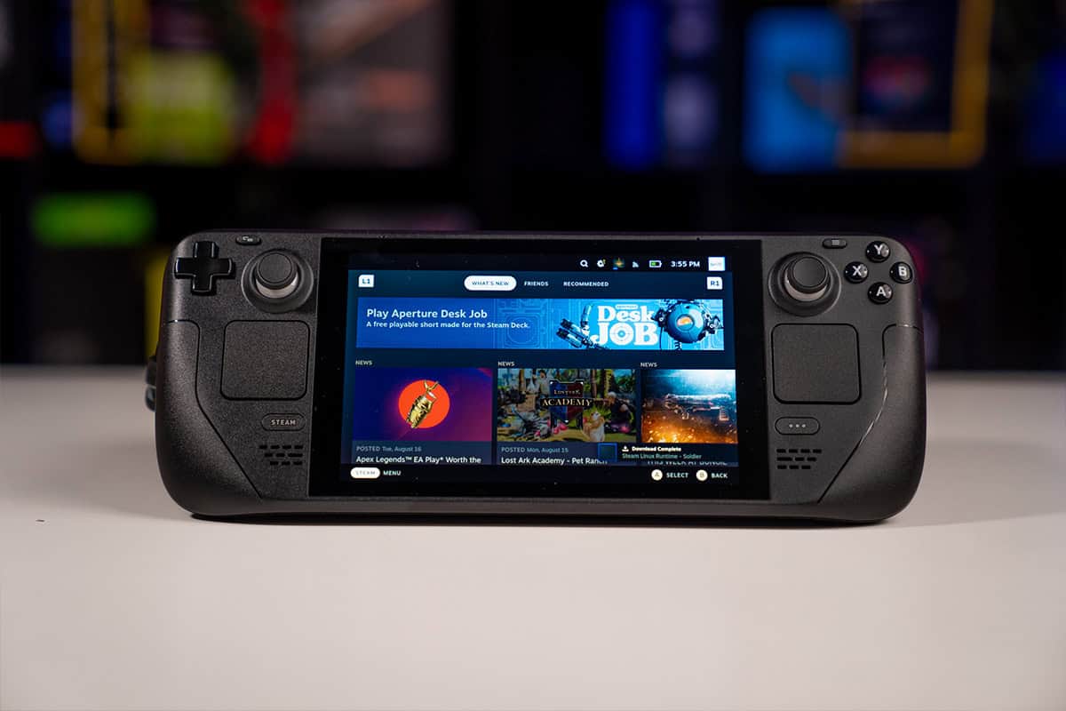 A handheld gaming console, resembling the Steam Deck, displays a home screen with game options. The console features dual thumbsticks, a D-pad, and various buttons on the front. An upcoming SteamOS update promises improved deadzone settings for enhanced gameplay precision.