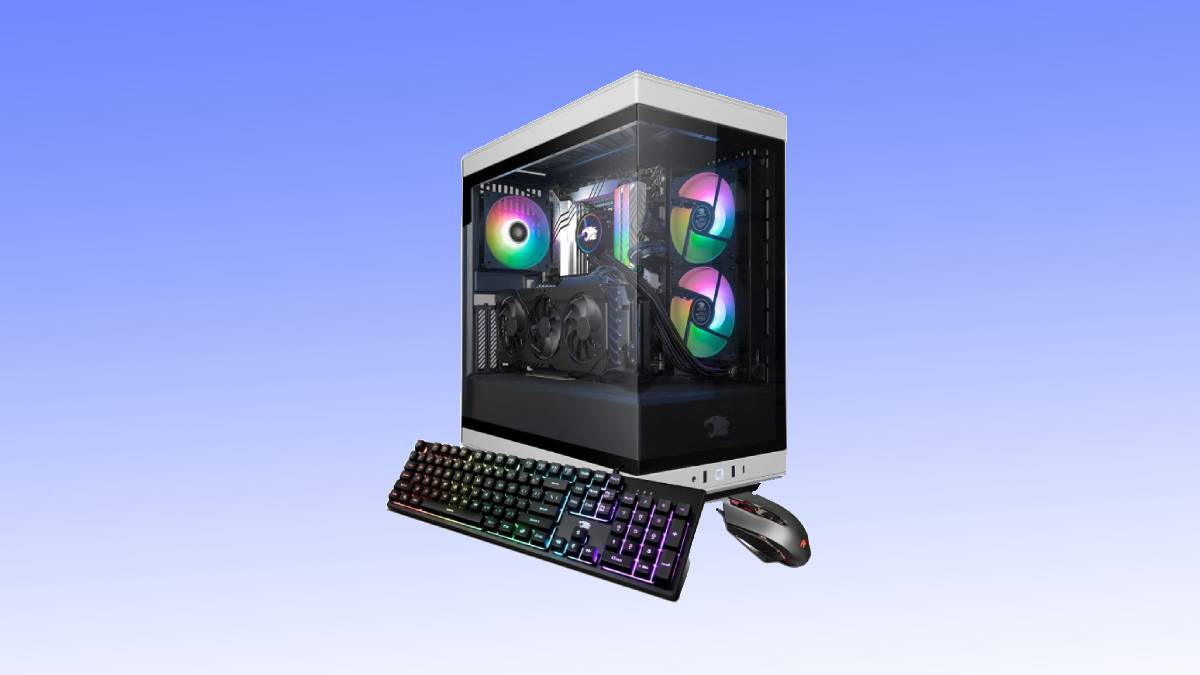 A gaming PC setup with a transparent tower case displaying internal components and multicolored LED lights, accompanied by a mechanical keyboard and a gaming mouse.
