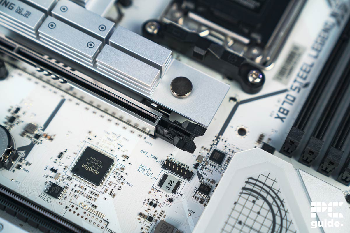 ASRock X870 Steel Legend PCIe latch and NVMe button, Image by PC Guide