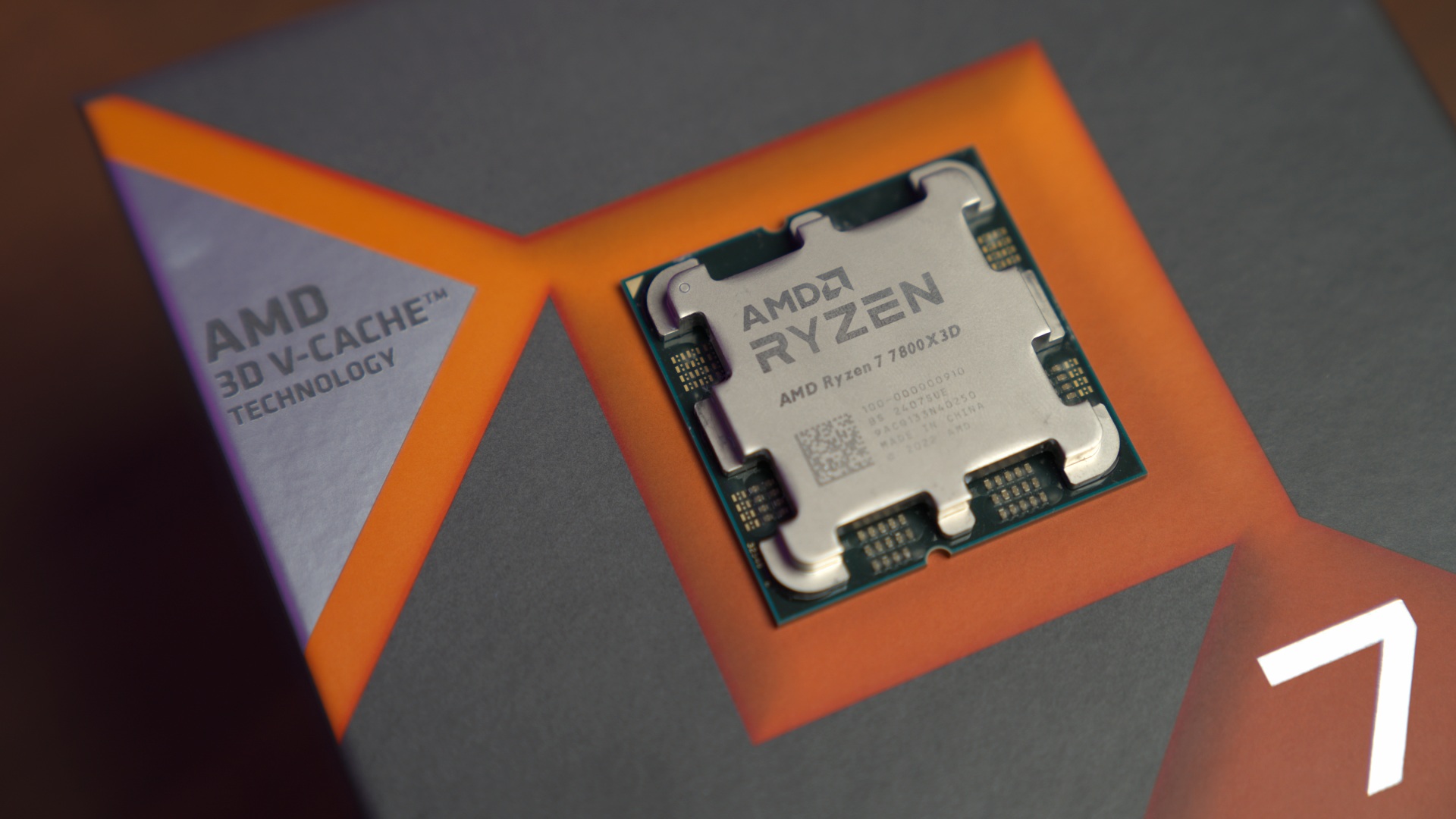 AMD Ryzen 7 7800X3D processor resting on packaging, image by PC Guide