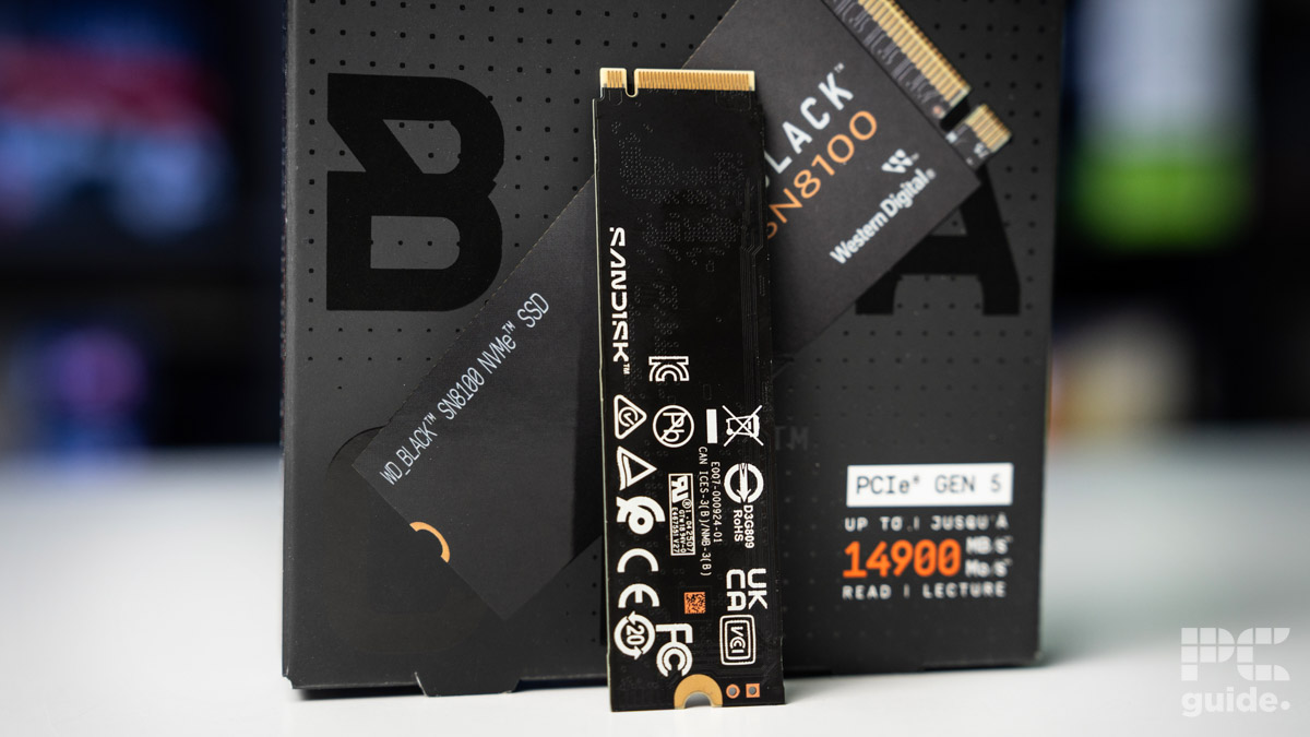 The WD_Black SN8100 NVMe SSD standing up leaned against its box with its back towards the camera.