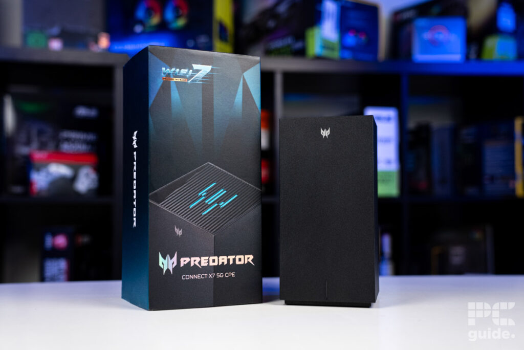 The Acer Predator Connect X7 5G CPE next to its box sitting on a white table with a background of blurred PC component boxes
