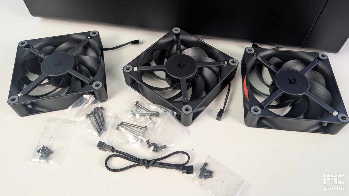 A set of three 120mm HAVN fans set out on the table with bags of various screws and a 4 fan extension lead.