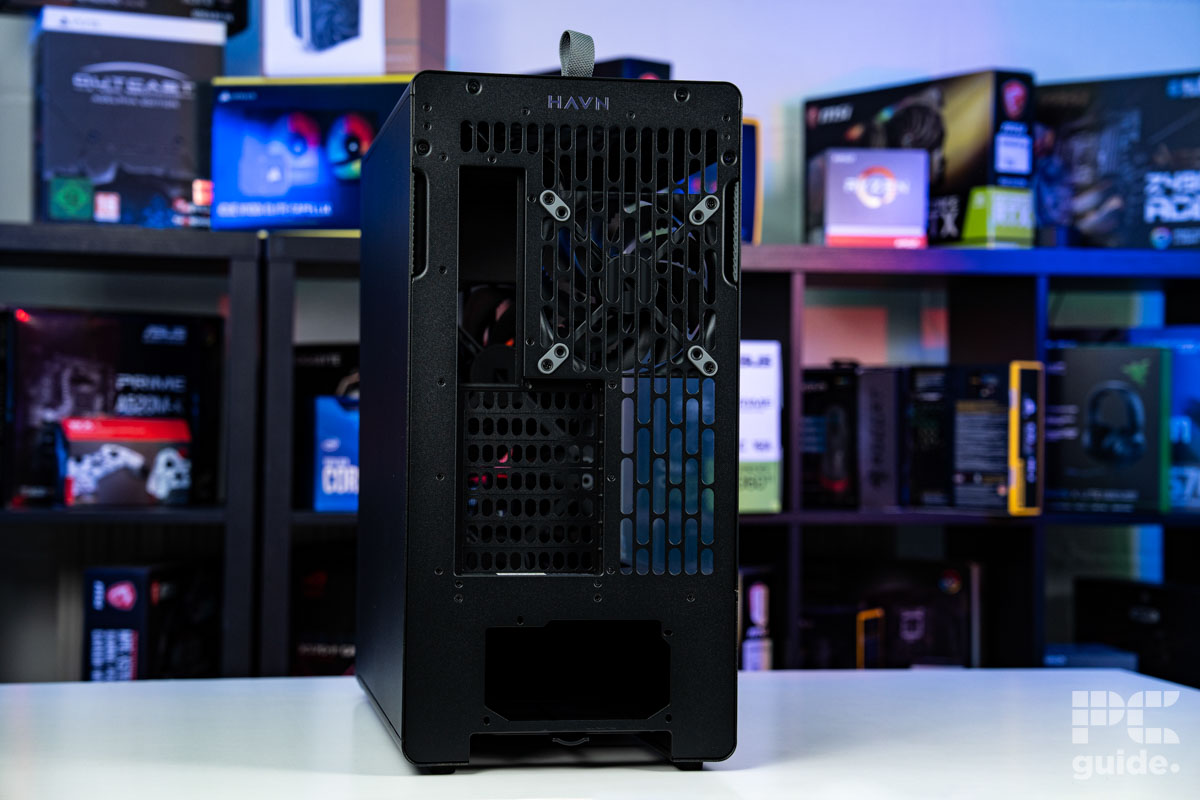 The back of the HAVN BF 360 Flowat an angle. It stands of a white table with a background of PC component boxes on a bookshelf.