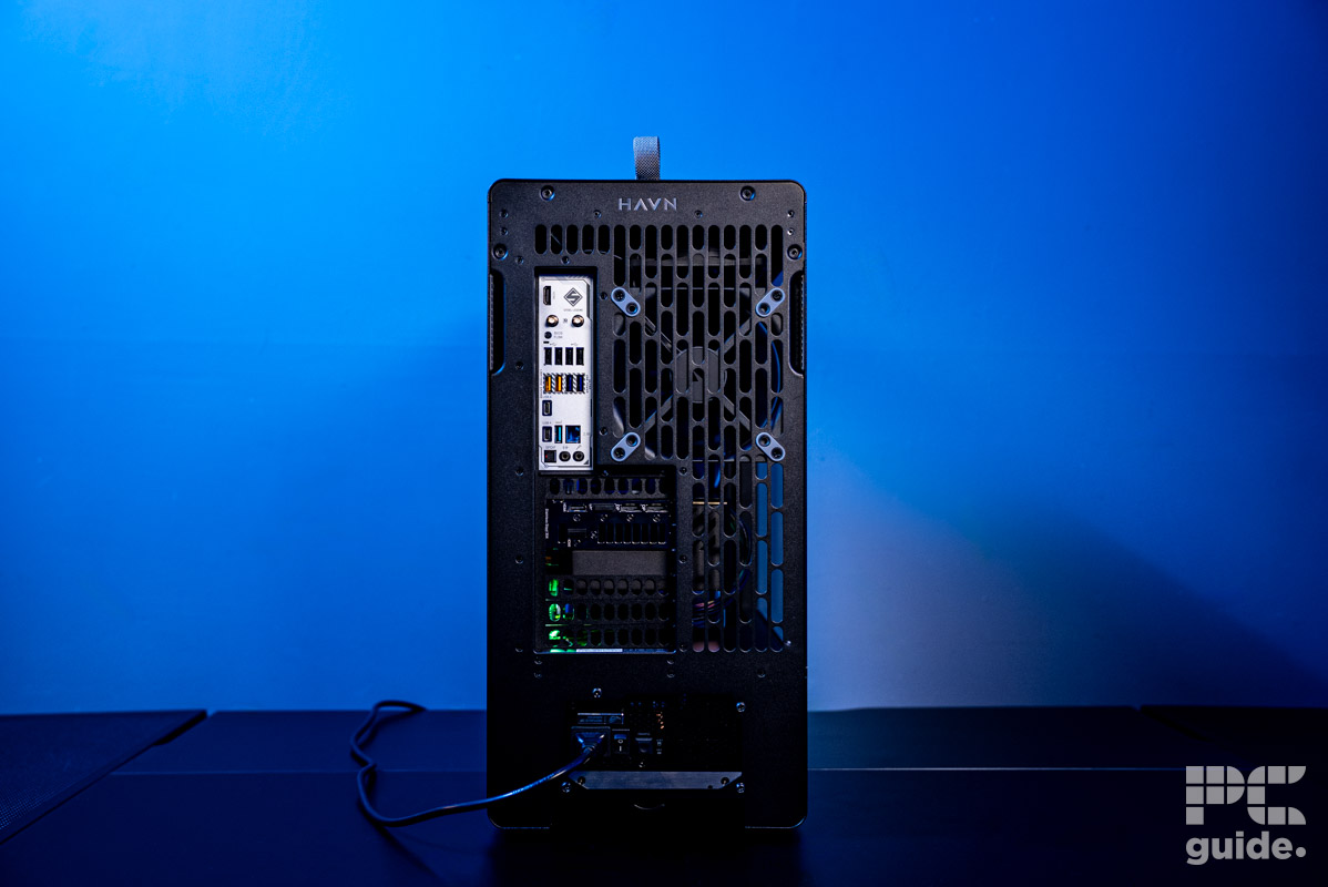 The rear of the HAVN BF 360 Flow case with components inside standing on a table with a background of a blue wall.